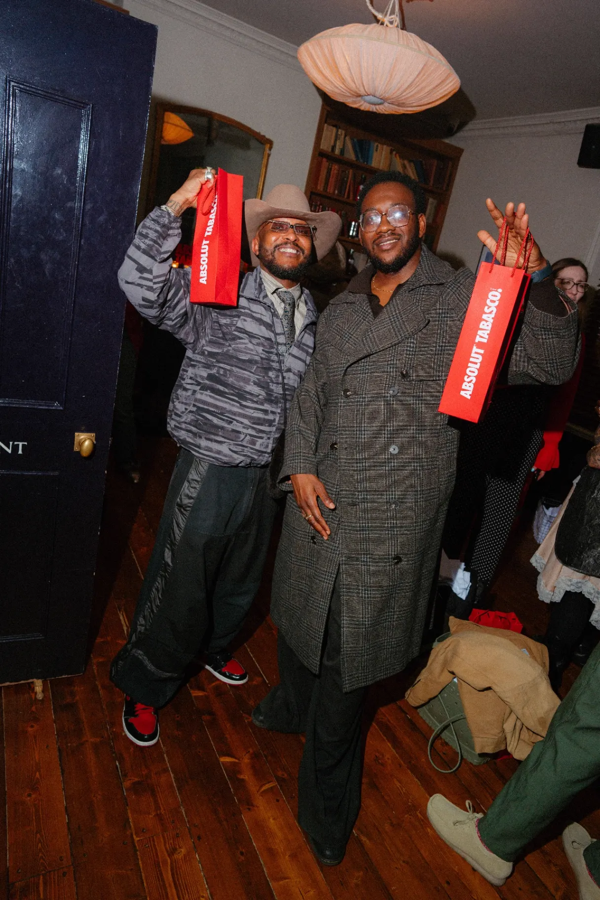 Guests holding red Absolut Tabasco branded gift bags at the launch event